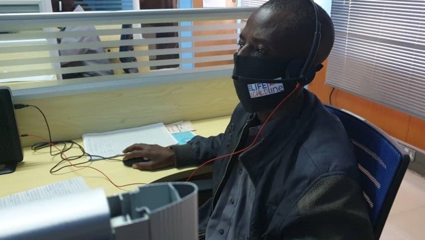 A Child Helpline operator in Zambia sits in front of a computer