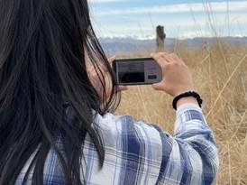 A woman using an app from the Terraso toolkit