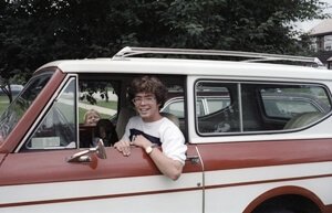Jim Fruchterman stands next to a rocket on a launch pad before it launches